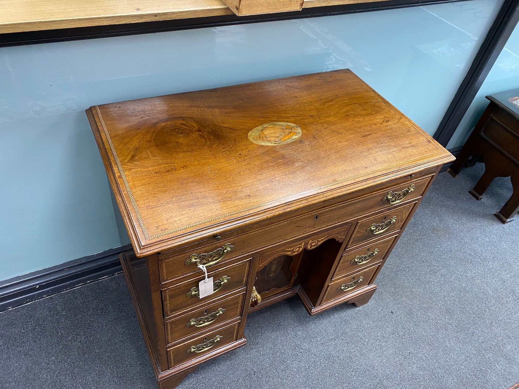 A George III later marquetry inlaid mahogany kneehole desk fitted slide, width 87cm, depth 50cm, height 79cm